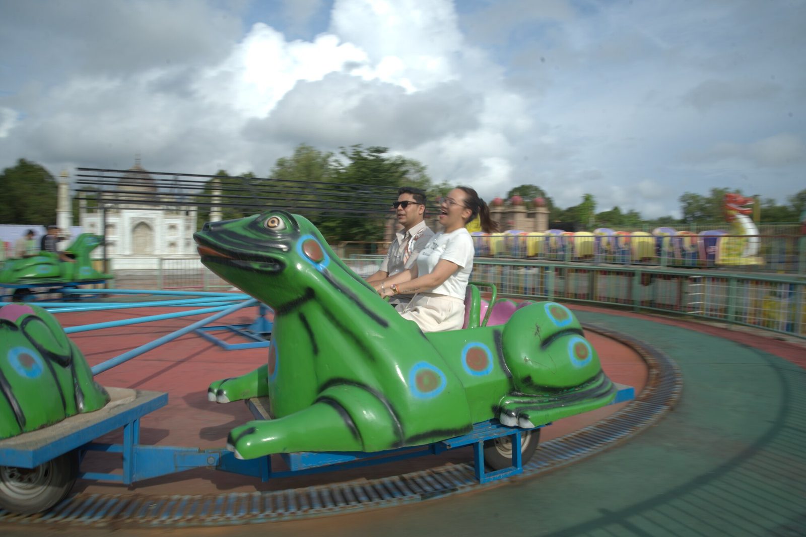 Two riders on the frog-themed family ride