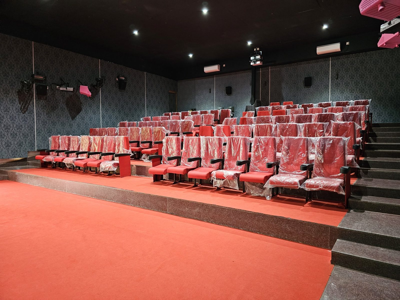 Inside the 3D theatre with rows of red seats